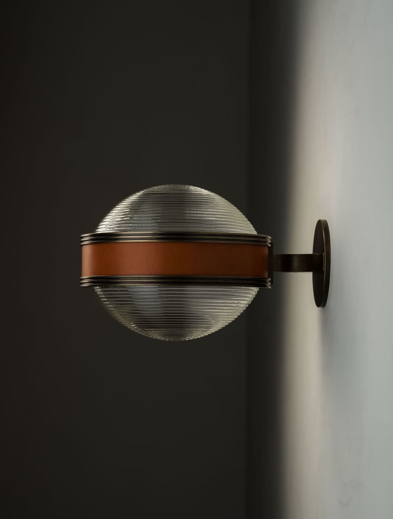 Monoscope Nautilus Sconce shown in Bronze and Tan Leather.
